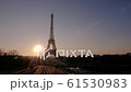 View of the Eiffel Tower from the Trocadero Gardens at dawn. The sun rises from the horizon. 61530983