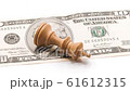 Defeated King Chess Piece Lying On A Dollar Banknote, Zoom Out 61612315