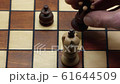Checkmate With Pawn And Queen On A Wooden Chess Board, Slow Motion 61644509