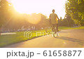 Man in yellow shirt riding a bike 61658877