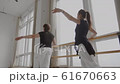 Trainer and student train at the bars side view 61670663