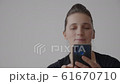 Close-up video of a young woman holding a mobile phone in her hands 61670710