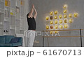 Young man doing yoga on the carpet at home side view 61670713