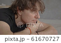 Young man resting on the carpet after yoga close-up 61670727
