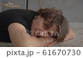 Close-up video of a young man relaxing on a carpet at home 61670730
