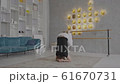 Man doing yoga on the carpet at home side view 61670731