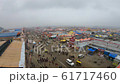 POV one looks on Kumbha Mela tent camp like real city a lot of people and cars on street cloudy 61717460