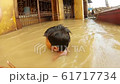 two little indian boys bathes in troubled water flooded holy river Ganges Manikarnika Ghat boats 61717734