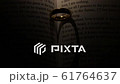 Golden wedding ring on bible book 61764637