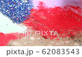 Making of colorful Rangoli with red coloured powder during Diwali, Indian religious festival 62083543