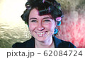 Cheerful housewife in hair curlers posing 62084724