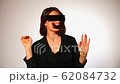 A modern housewife in rectangular glasses and 62084732