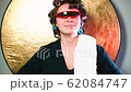 A cheerful housewife with curlers on her head and 62084747