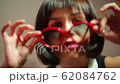 Portrait of a beautiful girl in red glasses at a 62084762