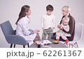 Blonde mother with 7 year old son and little daughter at the doctor's office 62261367