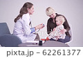 Blonde mother with 1 year old daughter at the doctor's office. medical checkup 62261377
