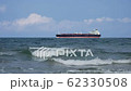 Oil tanker passing on the horizon. Realistic 3d animation of an oil tanker passing offshore on the horizon, integrated in real footage of waves. wide shot 4k 62330508