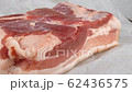 raw pork belly on white wrapping paper closeup rotating 62436575