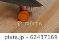 cutting carrot into slices on a cutting board with a kitchen knife closeup 4k 62437169