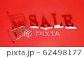 Small empty shopping trolley cart, word SALE and falling white letters casts a large shadow, on red background. Concept sale. Creative template for your text, design, ad or advertisement 62498177