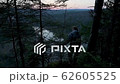 Person looking down at beautiful river valley from high point of mountains, back view 62605525
