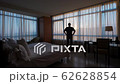 Silhouette of man standing alone against window in empty room 62628854