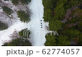 Group of tourists with backpackers and ski poles climbing the mountains in winter. Climbers hike in the mountains 62774057