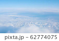 View from the window of the plane at the white clouds in the sky 62774075