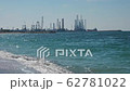 Construction of oil production towers in the Persian Gulf. Desert edifilled beach, waves. The 62781022