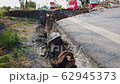 Asphalt road collapsed and fallen. Road collapses with huge cracks. 62945373