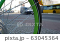 Green Spoke Wheel of A Bicycle With Traffic In The Background, Selected Focus 63045364