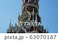 Close-up clock on Spasskaya Tower of the Kremlin against the blue sky on a sunny summer day. Sight 63070187