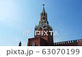The clock on Spasskaya Tower of the Kremlin against the blue sky on a sunny summer day. Sight of 63070199