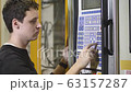 Production Worker / Machine Adjuster Adjusts the Automatic Injection Molding Machine to Start Production of Molding Housing for the Headlamps in Automotive Factory 63157287