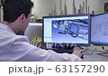 Designer Working on Desktop Computer, Screen Showing CAD Software with 3D Plastic Component for Automotive 63157290