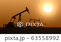 Oil pump jacks in the desert against sunset extracting crude oil 63558992