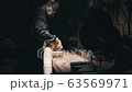Wood Worker use vacuum cleaner for collect shavings after work 63569971