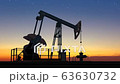 Oil pump jack extracting crude oil under starry sunset sky 63630732