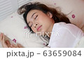 Asian woman suffers insomnia while worrying about work. 63659084