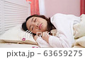 Woman is going to sleep a happy time to rest. 63659275