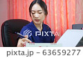 Woman sitting checking company documents for financial budget	 63659277