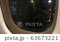 Drops of rain flow down the glass of an airplane window. View from the plane. 4K 63673221