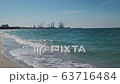 Construction of oil production towers in the Persian Gulf. Desert edifilled beach, waves. The 63716484