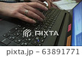 Woman's hands pressing keys on a laptop keyboard 63891771