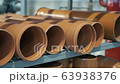 Orange PVC pipes stacked in construction site. Modern plastic sewer pipes 63938376