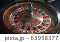 A shot of a casino roulette in motion,the ball stops at 12 red thirty six/Better luck next time 63938377