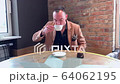 handsome guy drinks big coffee alone in a cafe 64062195