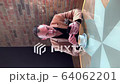 vertical video, a handsome guy drinks coffee alone in a cafe and writes on a smartphone 64062201