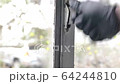 Hand with black rubber gloves is an opening window 64244810