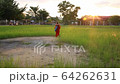 Tracking Shot Of Young Woman Walking Through City Square, On Her Way To Yoga Class, She Passes Under A Water Sculpture 64262631